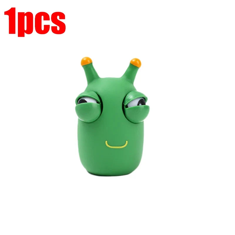Single green worm squeeze fidget toy with pop-out eyes and smiling mouth