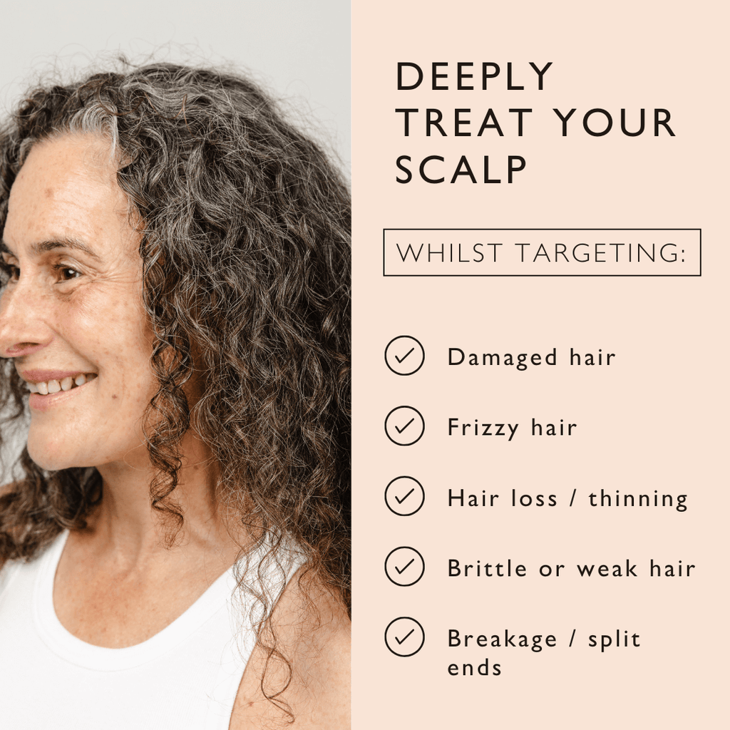 Woman with curly hair showing scalp, smiling in side profile