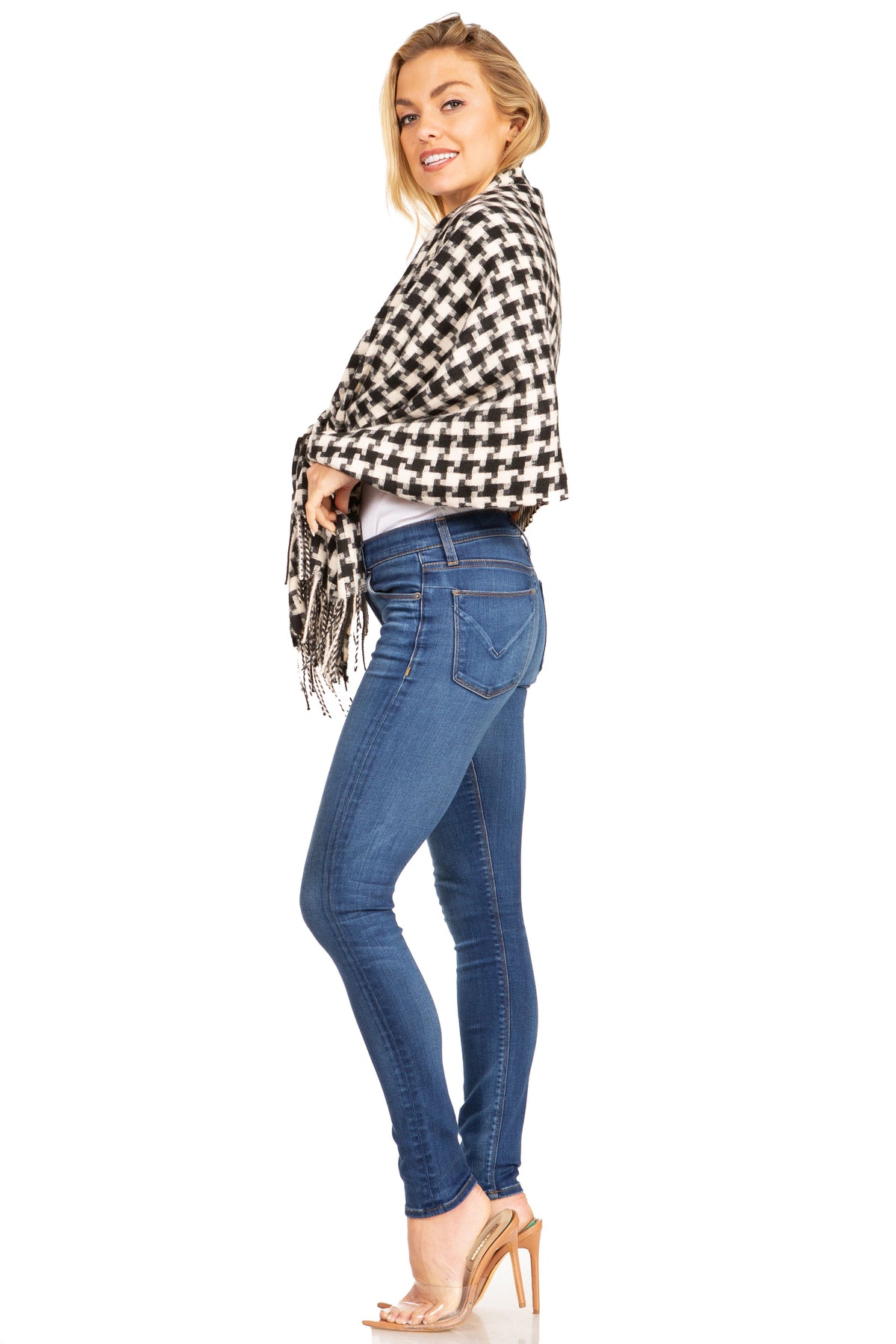 Black-and-white houndstooth wrap scarf with long fringe, worn over blue jeans
