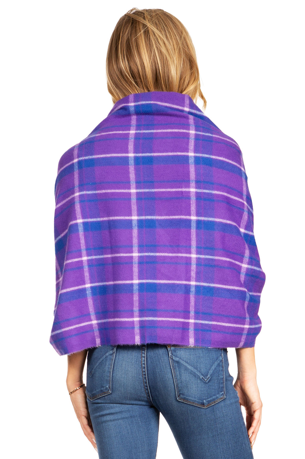 Purple plaid pashmina shawl wrap with fringed edges, worn over denim jeans