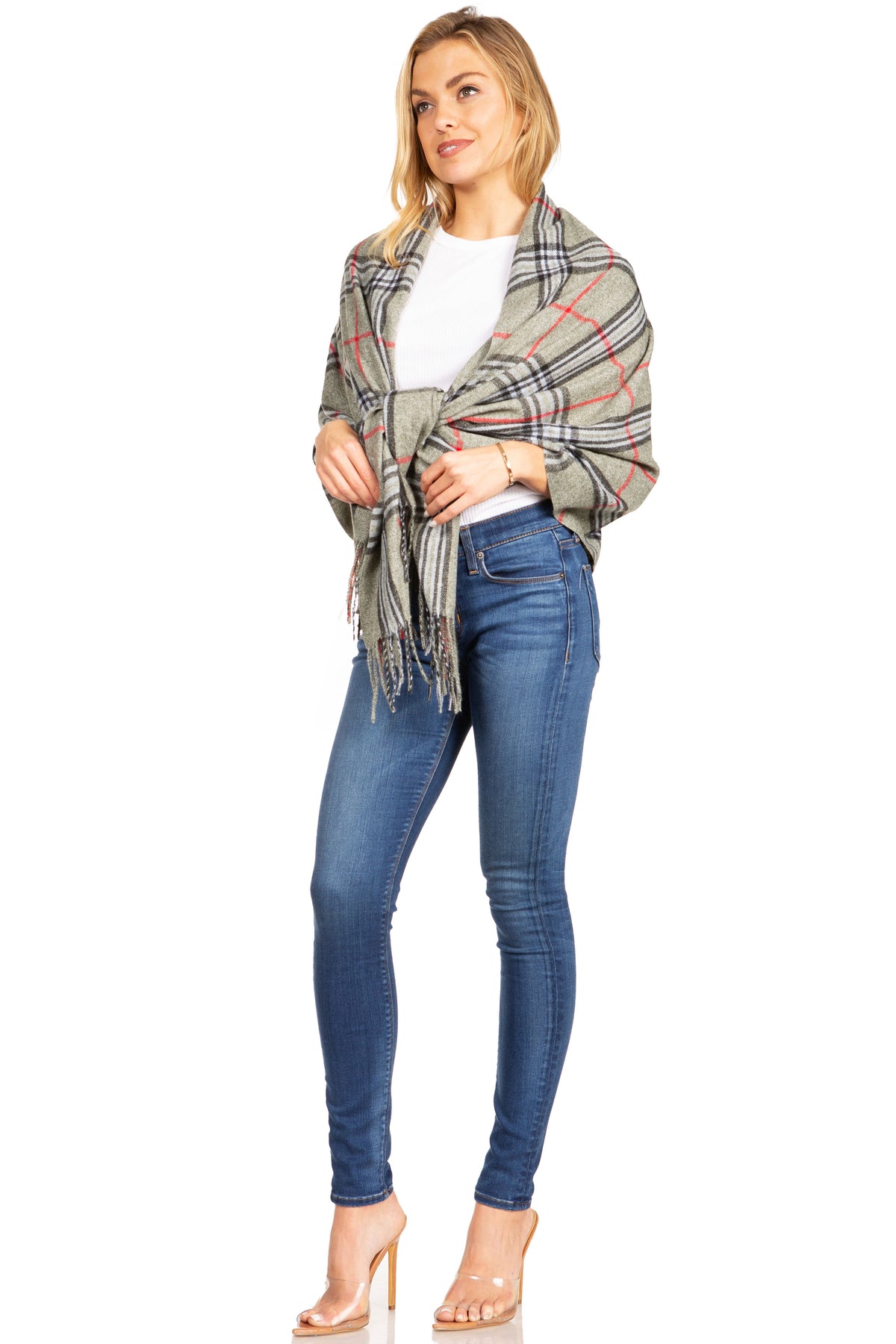 Plaid pashmina shawl in gray and red, with fringed ends, worn over white top
