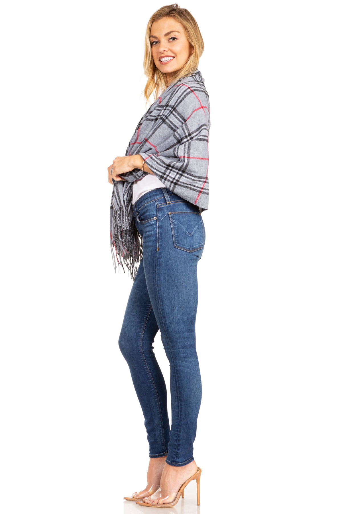 Plaid pashmina shawl in gray with red lines, worn to the side with long fringe