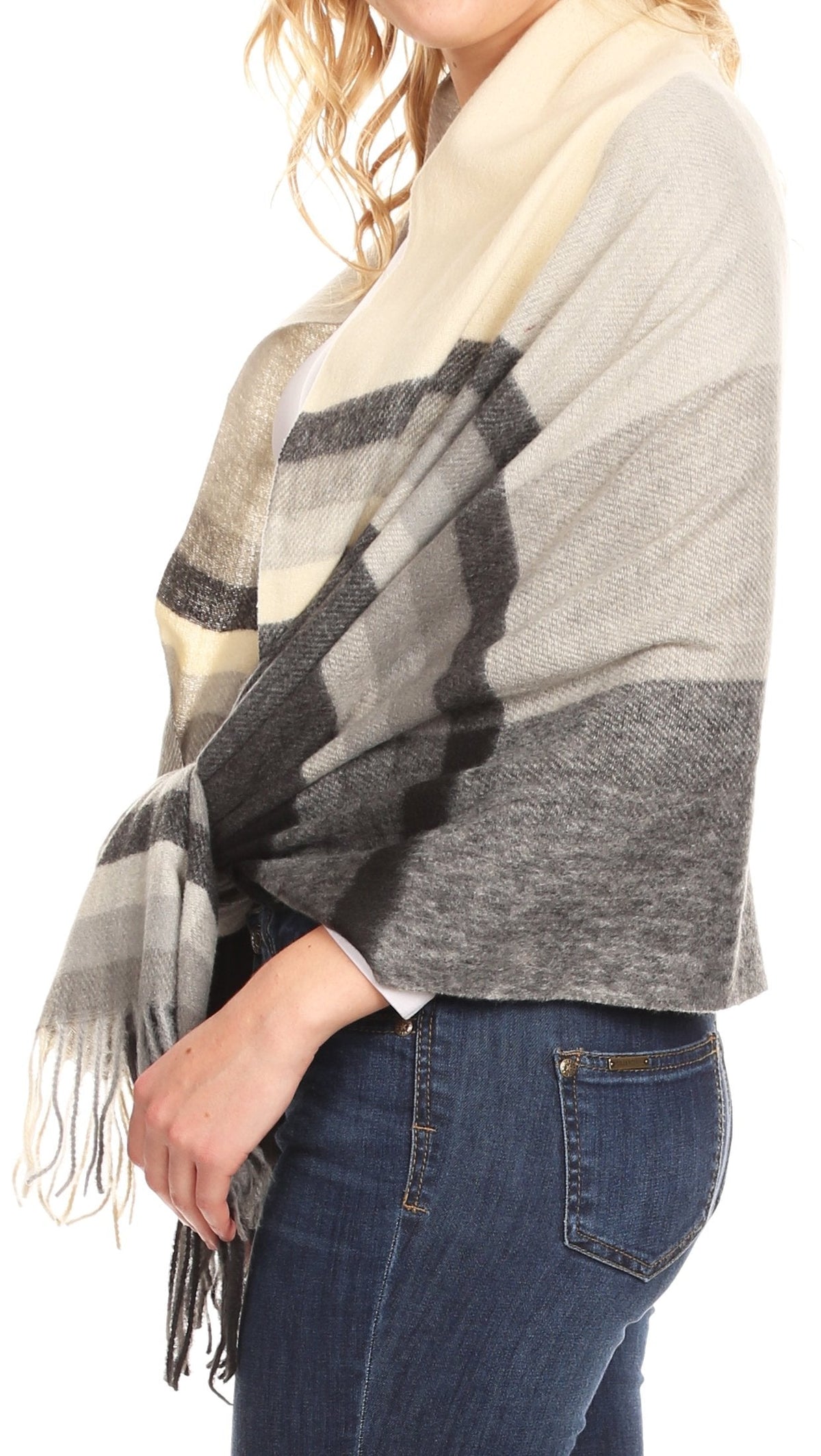 Light beige plaid wrap shawl with gray stripes and fringe, draped at shoulder