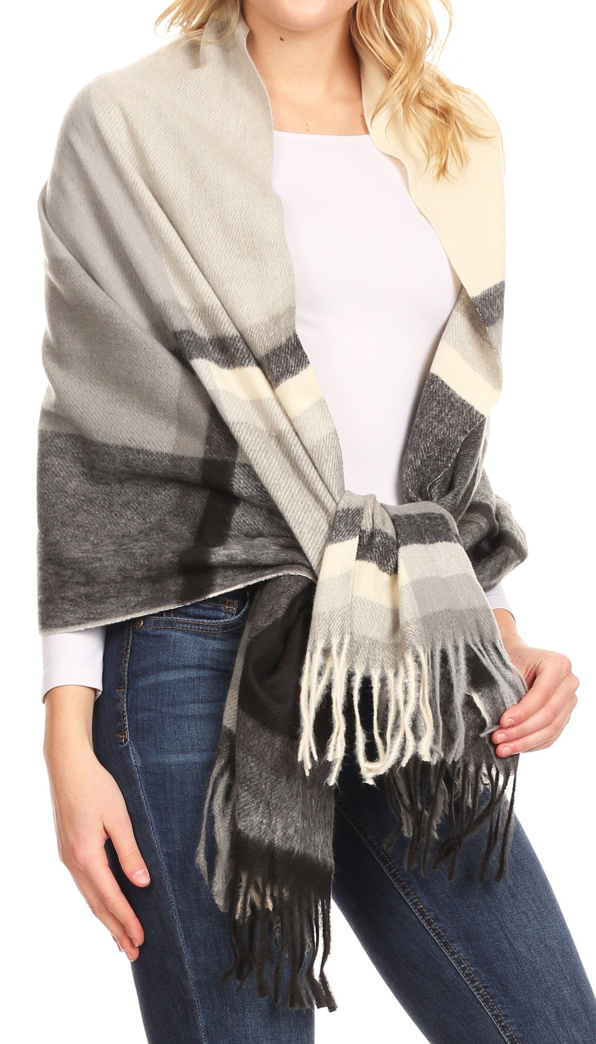 Beige and gray plaid pashmina shawl with fringe, partially wrapped across chest