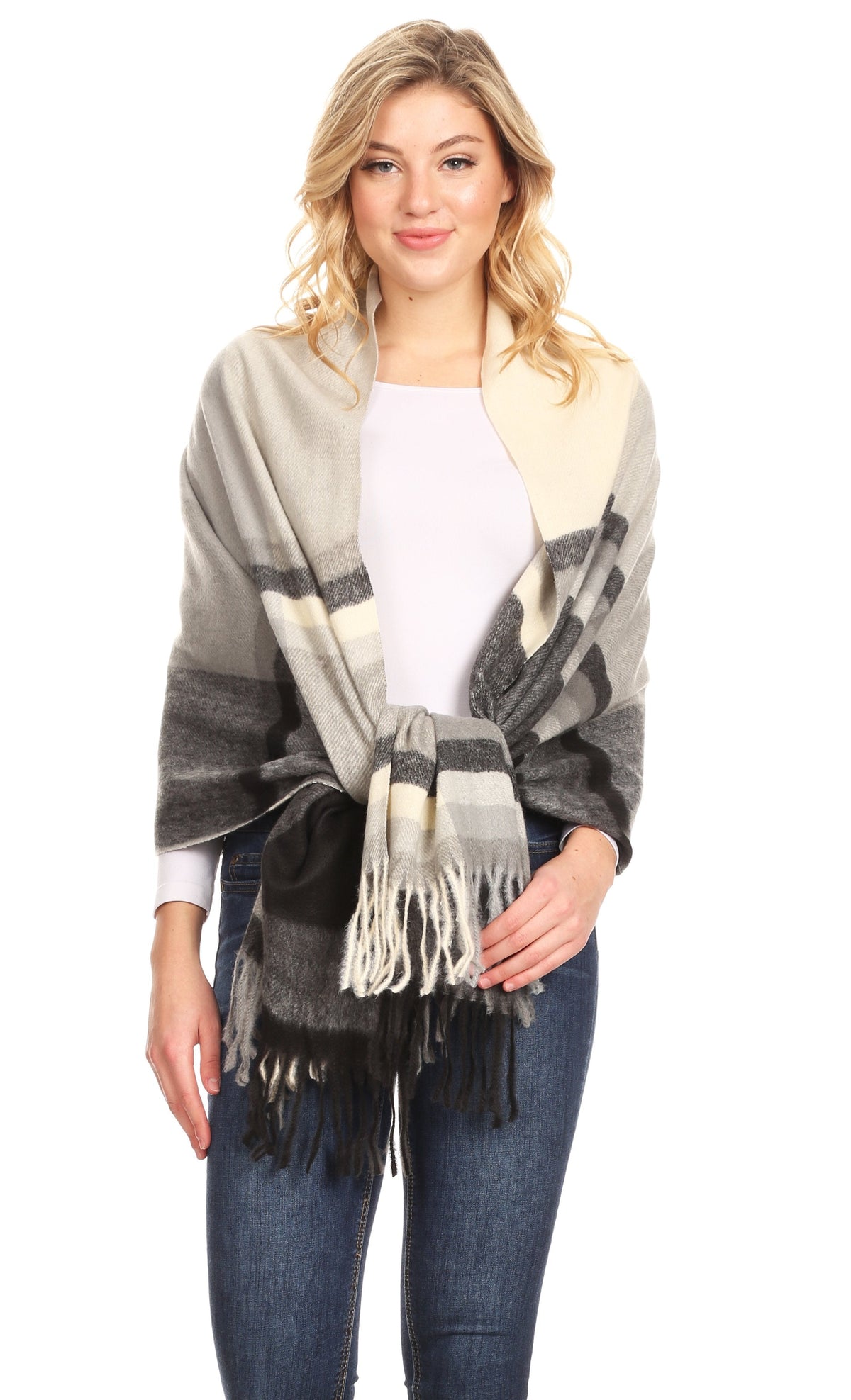 Beige-gray plaid shawl with fringe and bold stripe blocks, worn over a light top