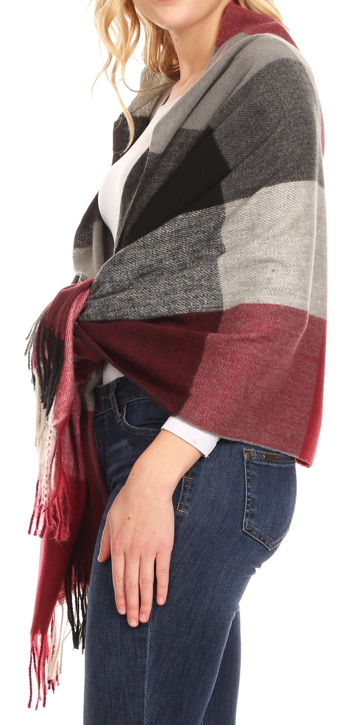 Women’s plaid pashmina shawl draped over shoulders; burgundy and charcoal with fringe.