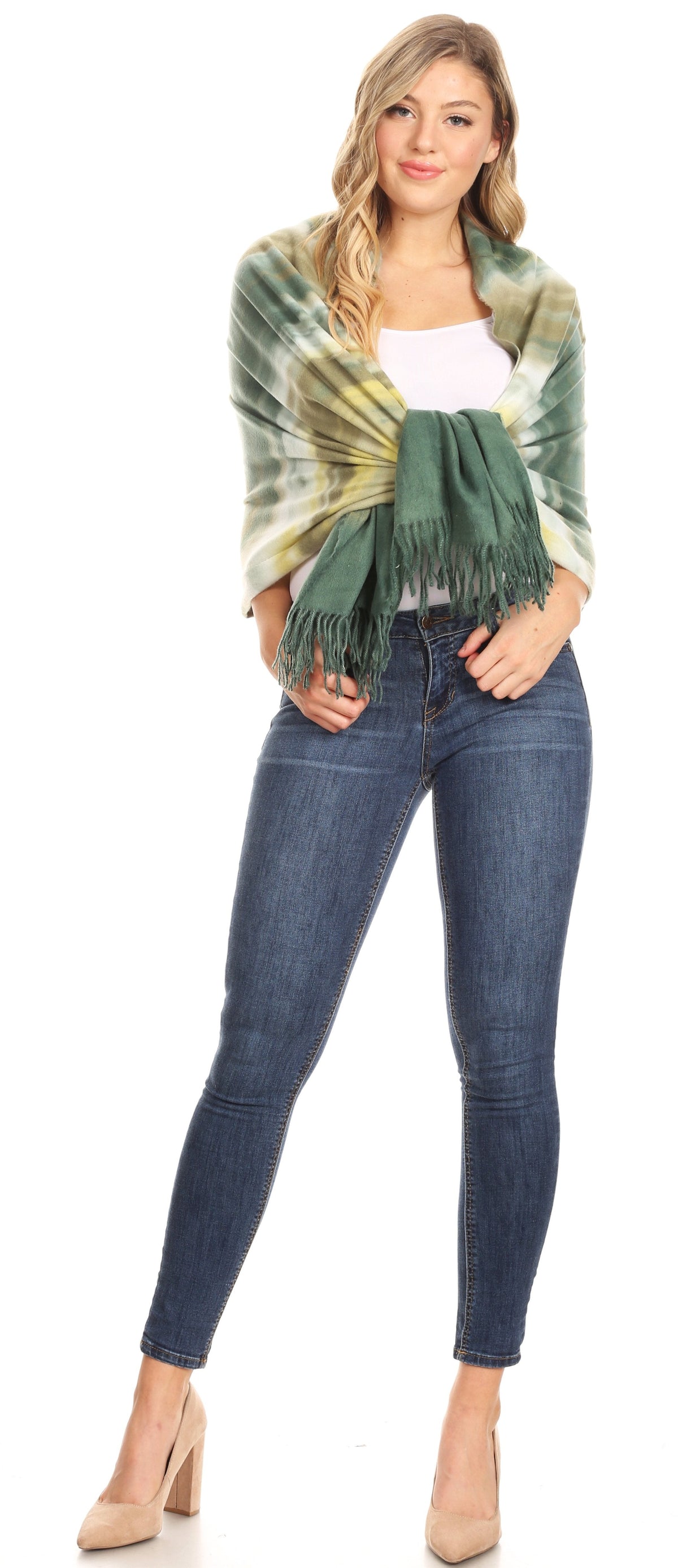 Women's green-and-yellow striped pashmina shawl with fringe, styled over jeans