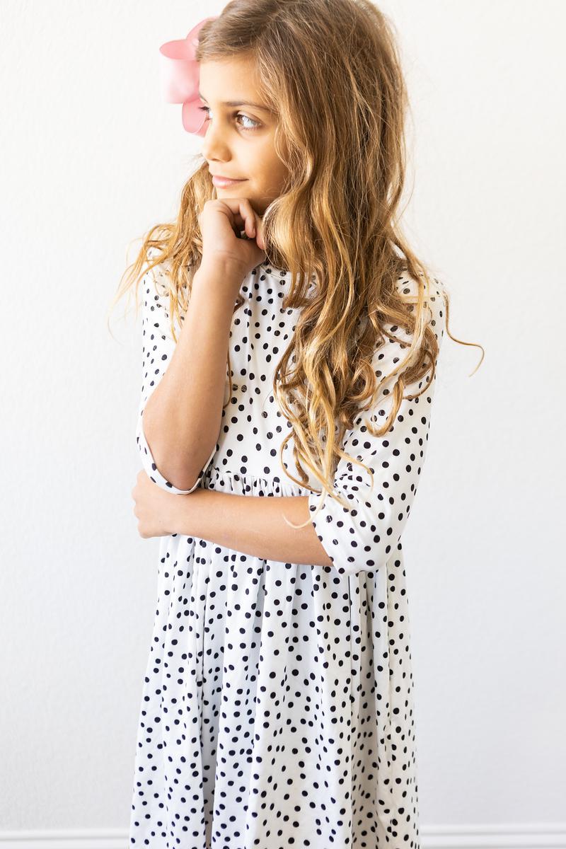 White polka-dot twirl dress with 3/4 sleeves and round neckline