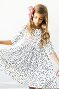 White polka-dot twirl dress with 3/4 sleeves and gathered skirt