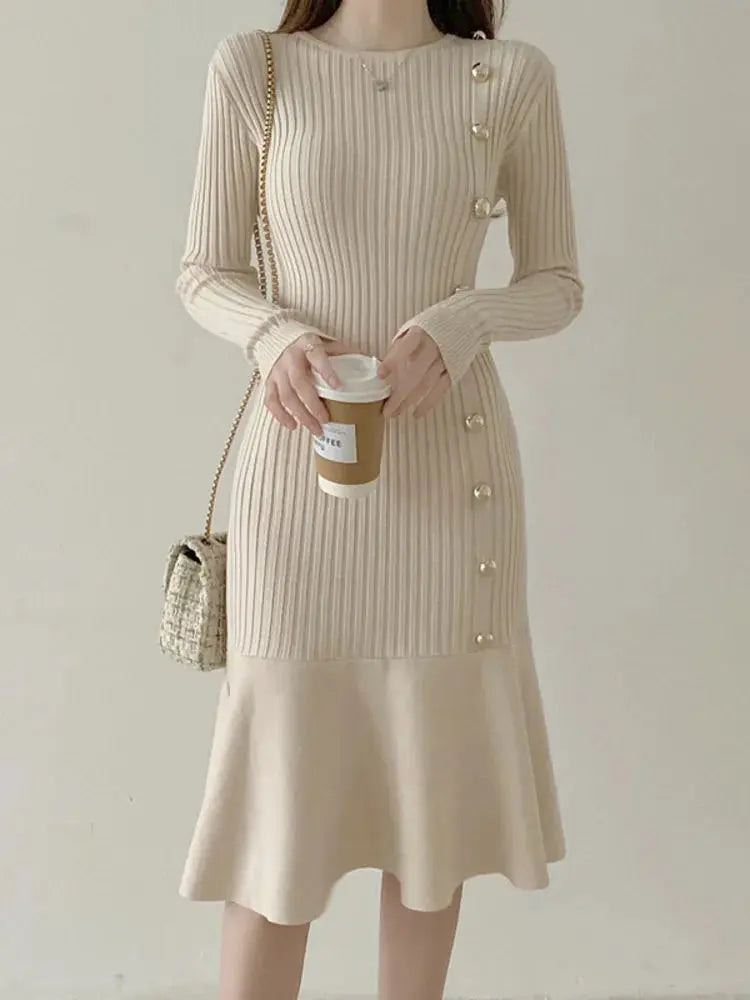 Apricot ribbed knit sweater dress with long sleeves, gold buttons, and flared hem.
