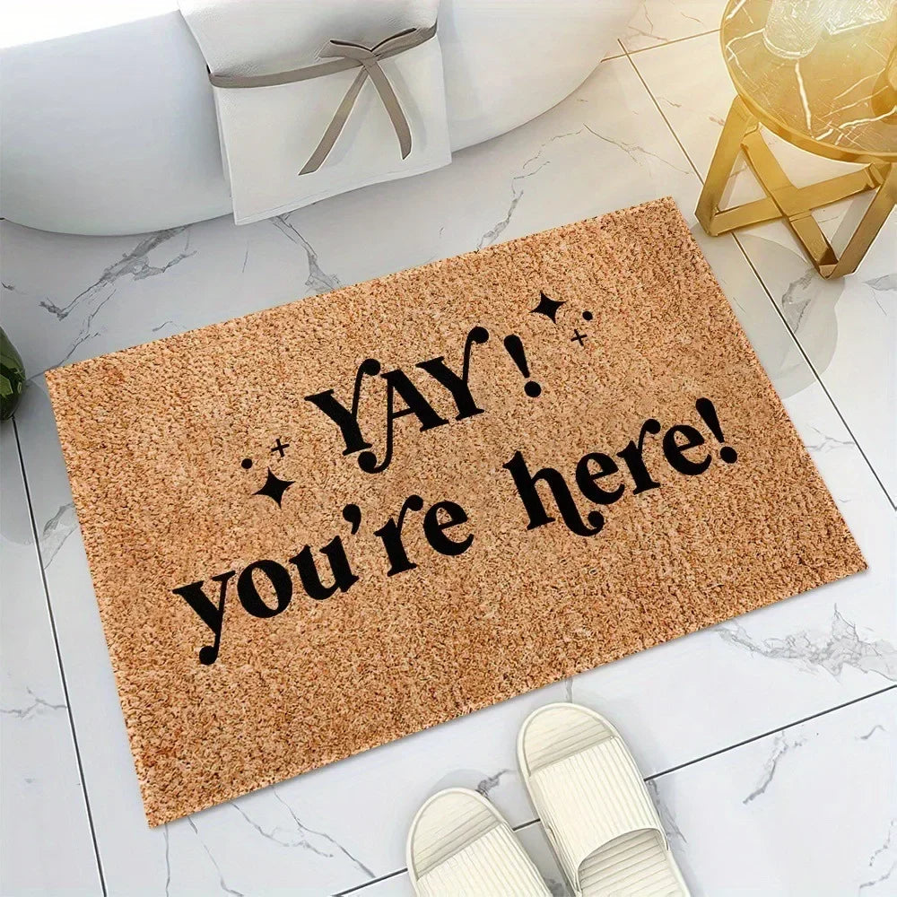 Tan doormat with “Yay! you’re here!” text and confetti star accents