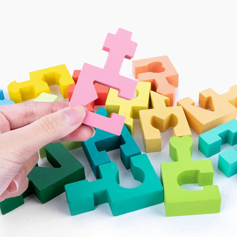 Hand holding a colorful wooden shape piece among assorted interlocking blocks