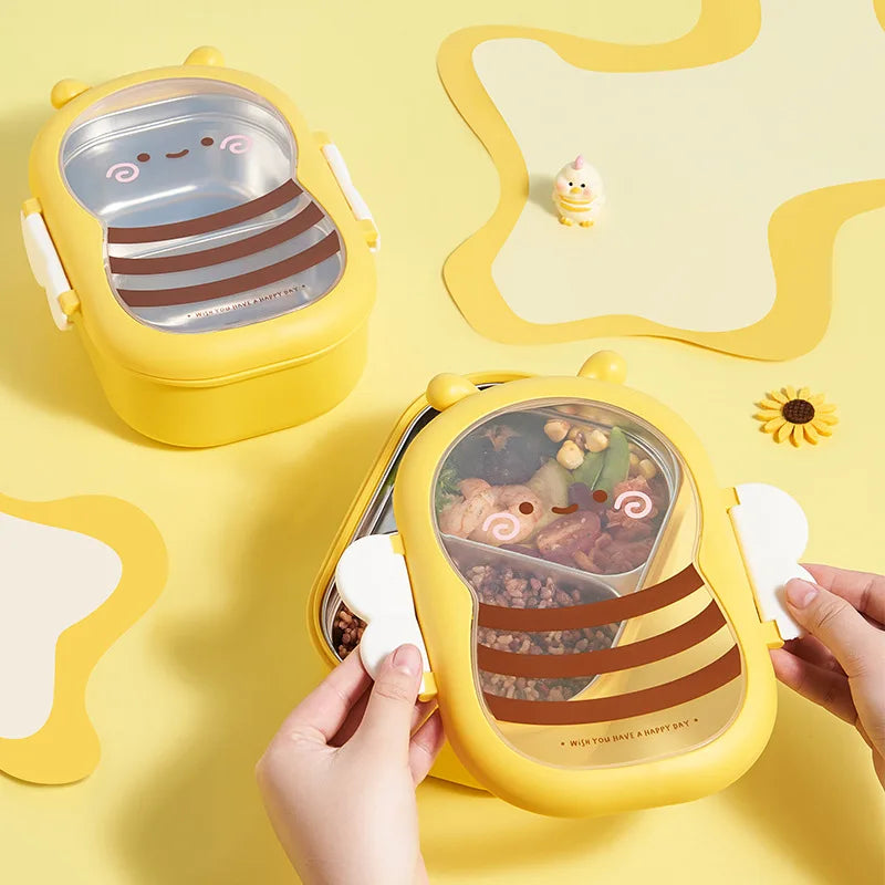 Yellow bee-shaped bento box with open lid showing fruit and mixed food
