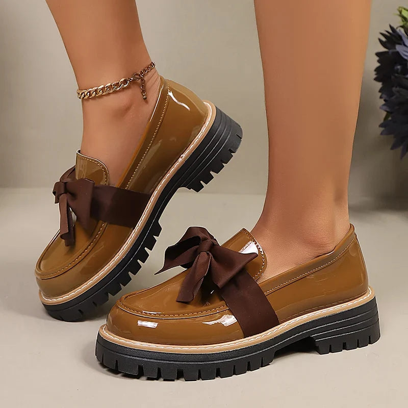 Brown bowknot platform loafers, glossy patent finish, chunky tread sole