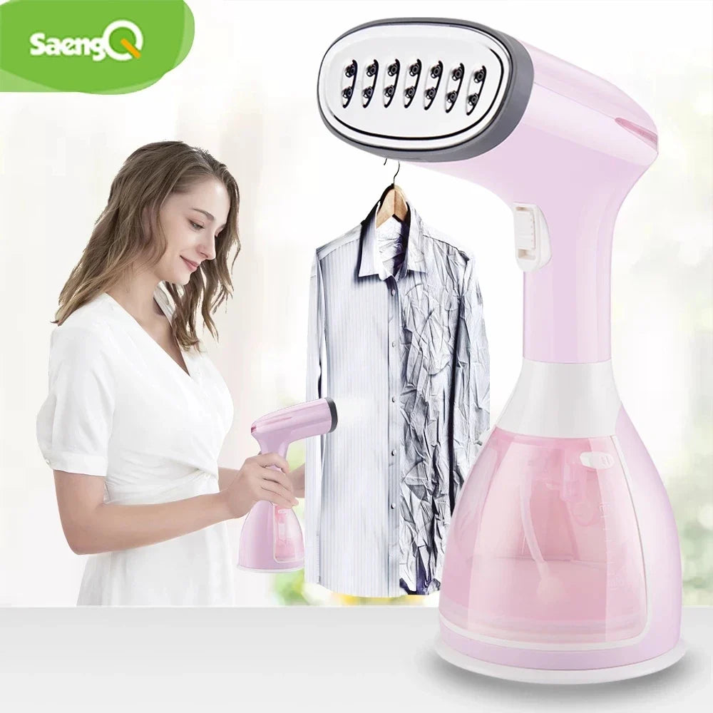 Handheld garment steamer in pink with oval steam head, holding a hanging dress shirt