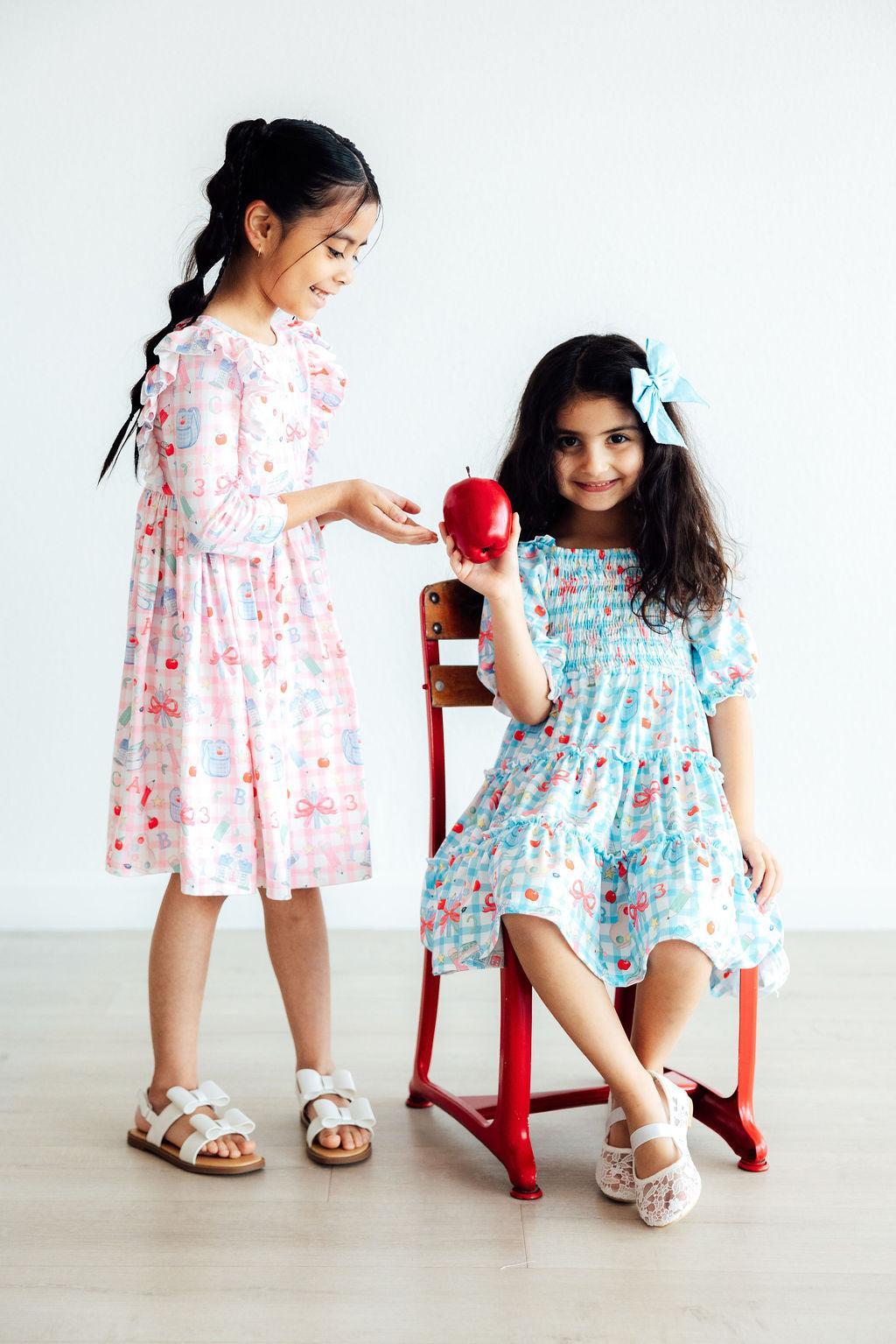 White and light blue printed 3/4 sleeve ruffle twirl dresses with bow-tie details