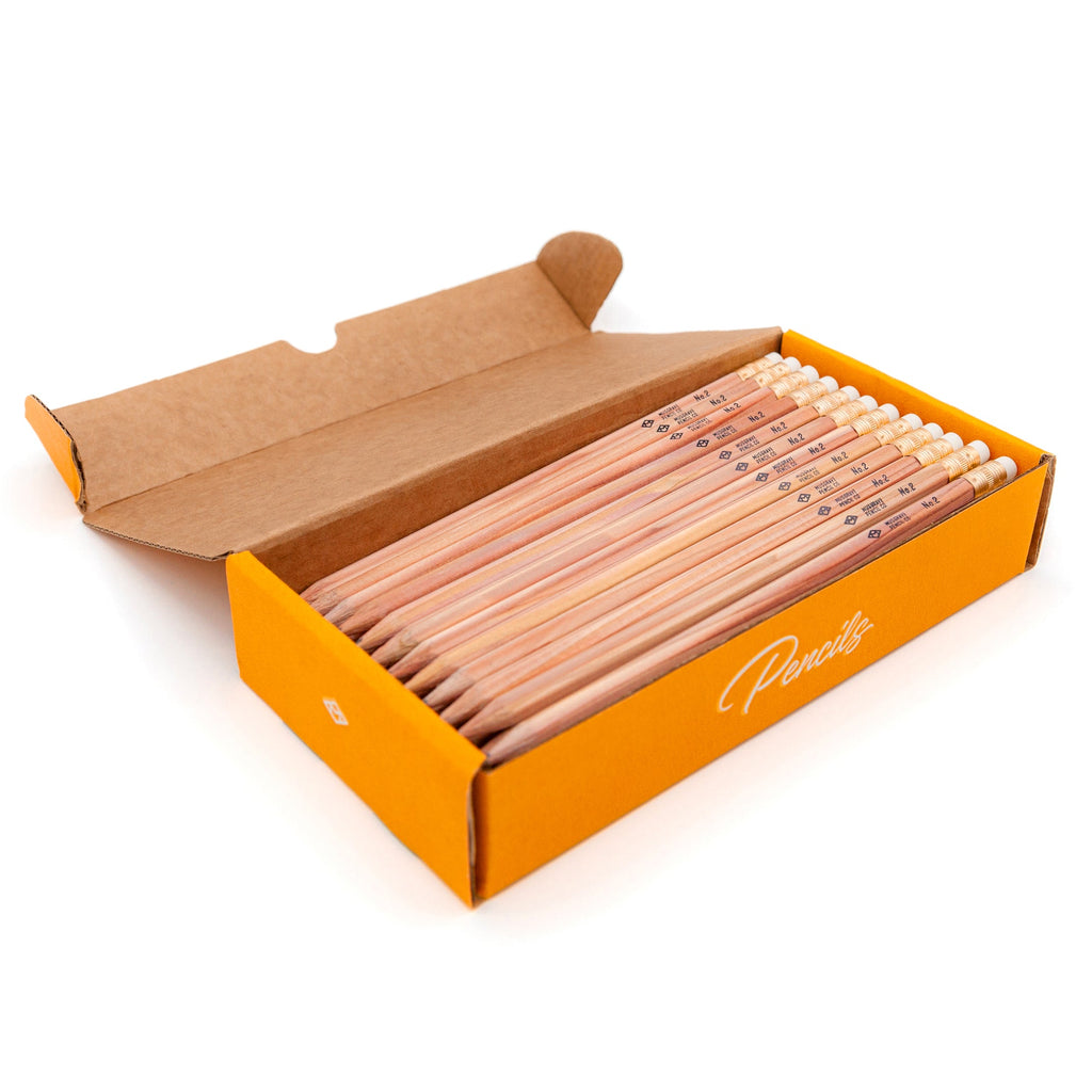 Wooden pencil pack with 60 pencils in open cardboard box, orange patterned labels