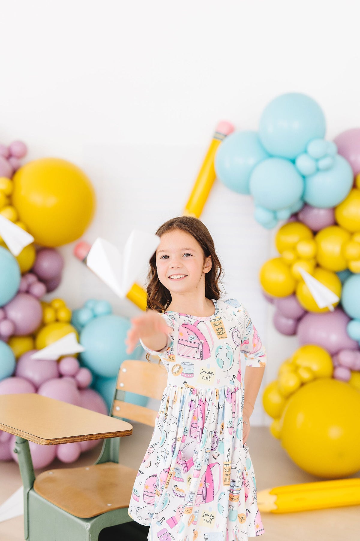 Girls' white 3/4-sleeve twirl dress with colorful school print and flared gathered skirt