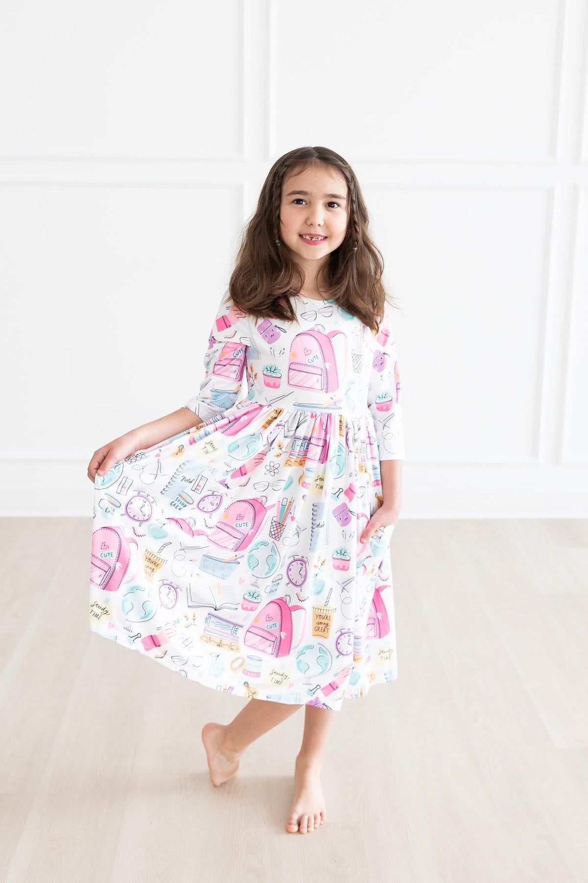 Girls' white 3/4-sleeve twirl dress with colorful school-themed print and flared skirt