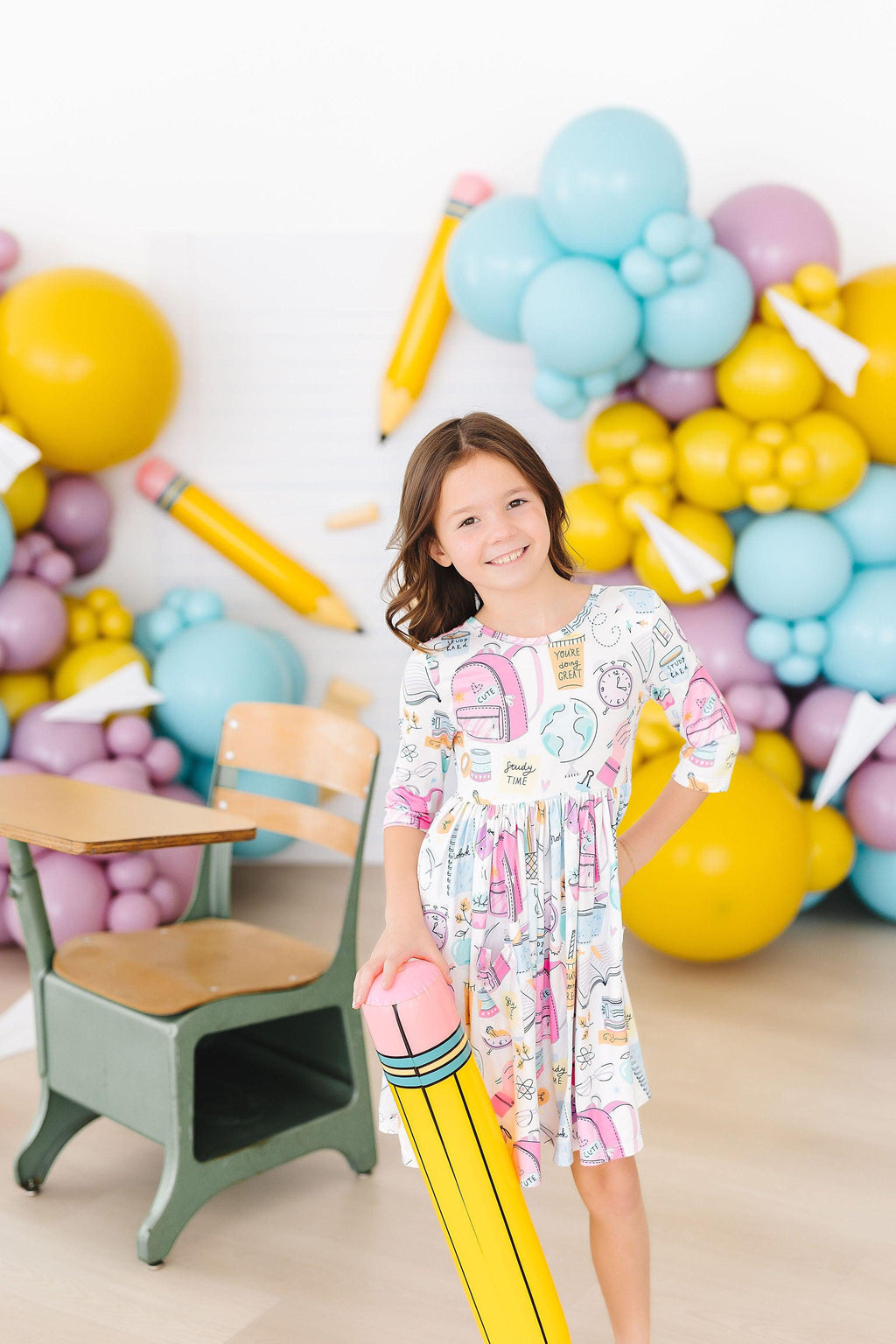 Girls' white 3/4-sleeve twirl dress with colorful school-themed print and gathered flare
