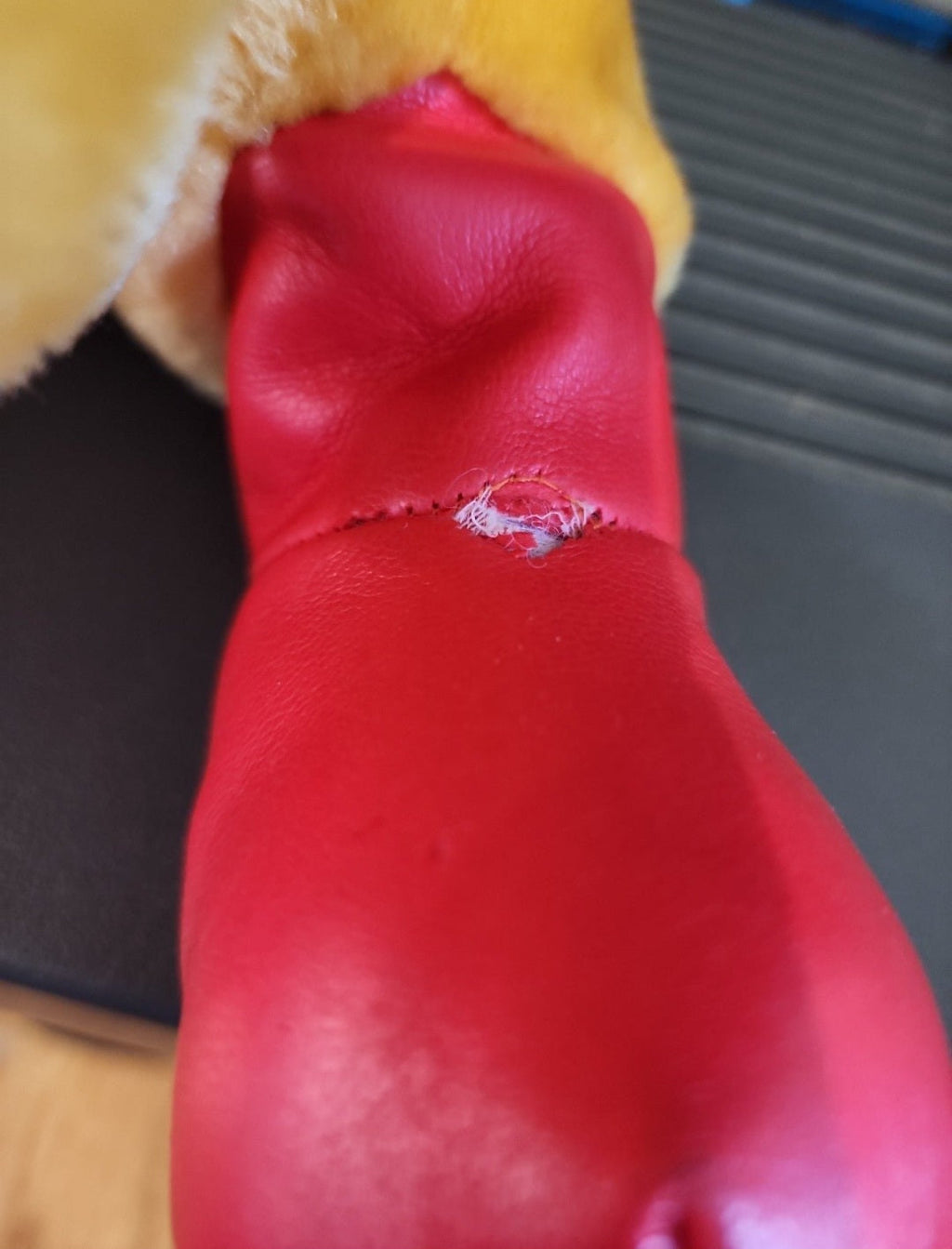 Red plush racing boot and seam detail on Winnie-the-Pooh bear