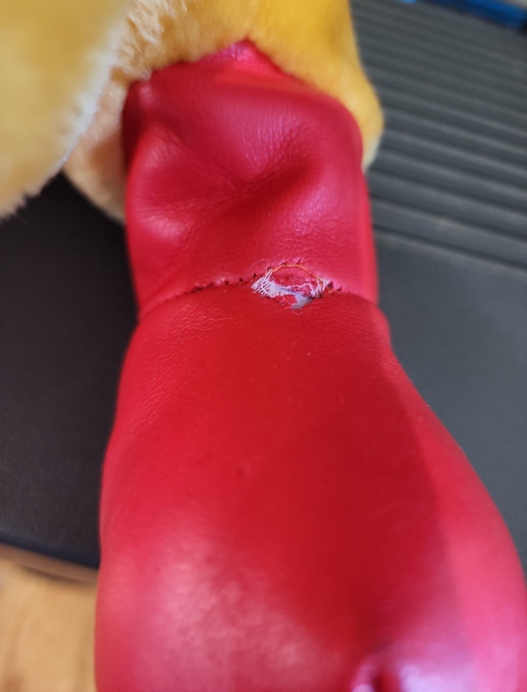 Red plush racing boot and seam detail on Winnie-the-Pooh bear