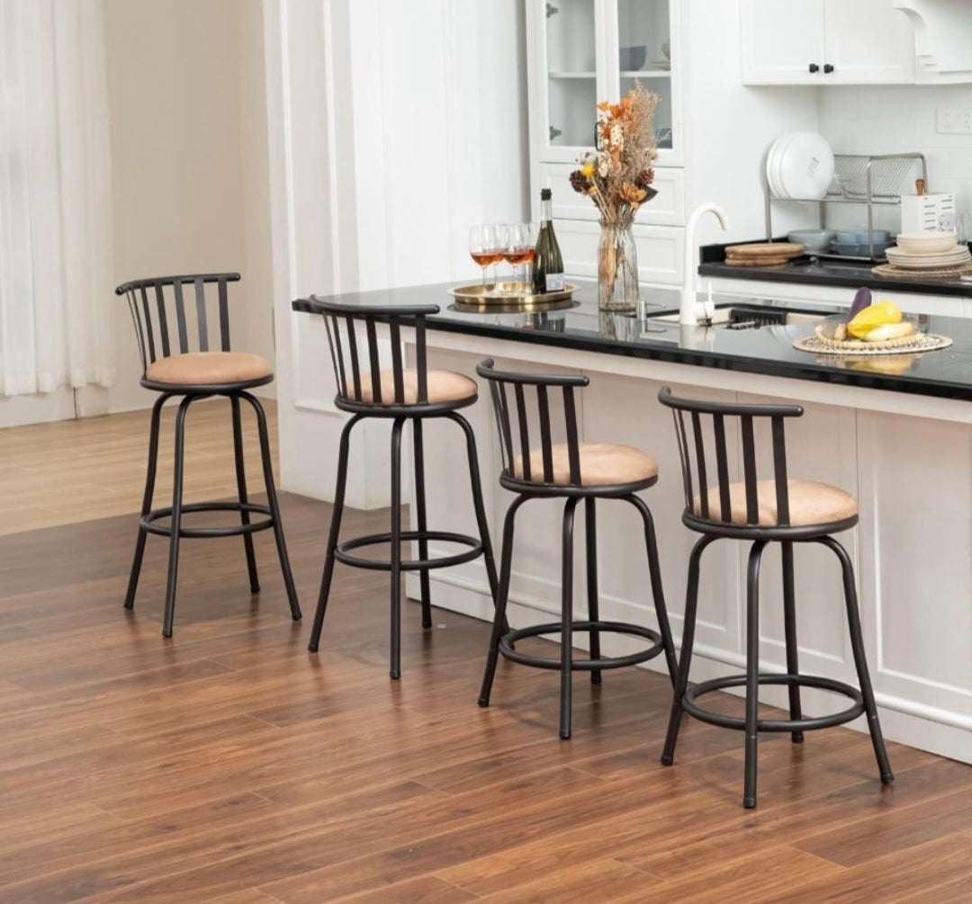 Counter-height barstools with black slatted backs, round tan padded seats, and round footrests.