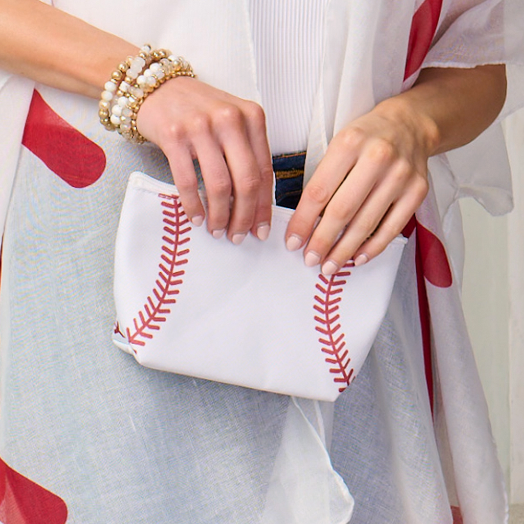 Baseball pouch in white with red seam pattern, held in hands