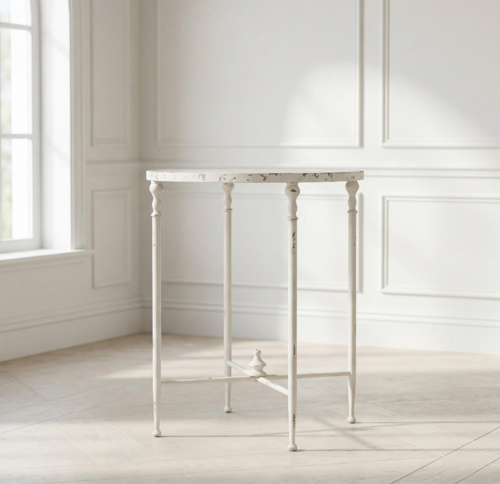 Antiqued metal round side table in antique white with turned legs and open apron