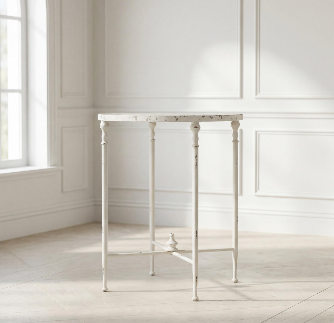 Antiqued metal round side table in antique white with turned legs and open apron