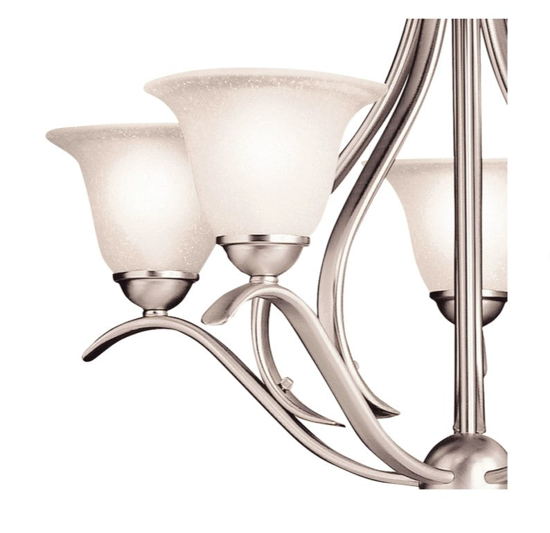 Nickel chandelier with curving arms and etched glass shades, close-up.