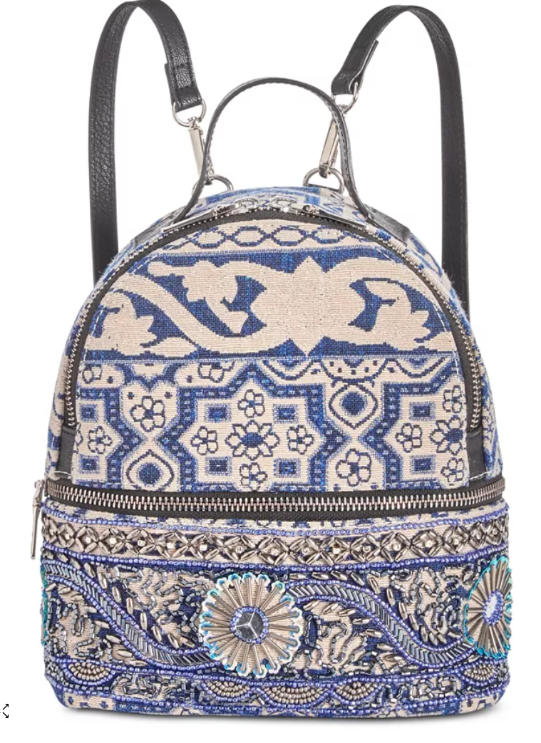 Steve Madden Duchess backpack, blue-and-cream patterned fabric with front medallion details