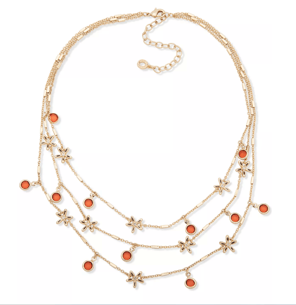 Gold-tone layered charm necklace with orange stone beads and star charms