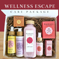 Wellness Escape care package box with Komoni skincare bottles, bars, and small candles inside