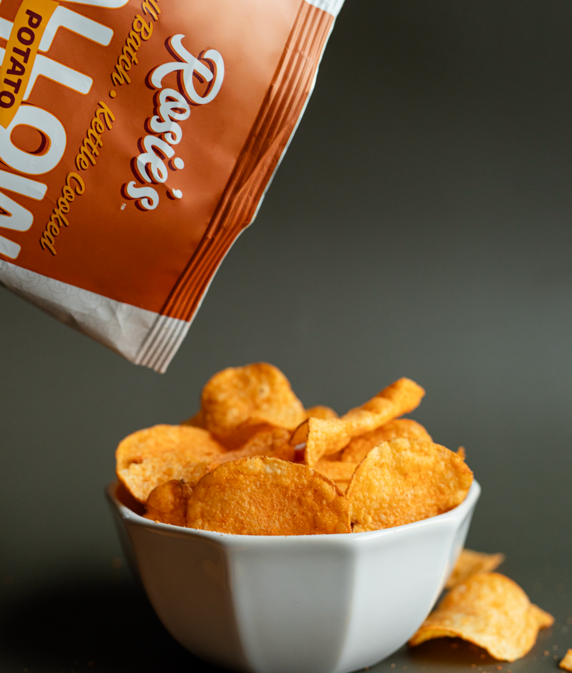 Tallow potato chips bag corner tipped toward a bowl of chips