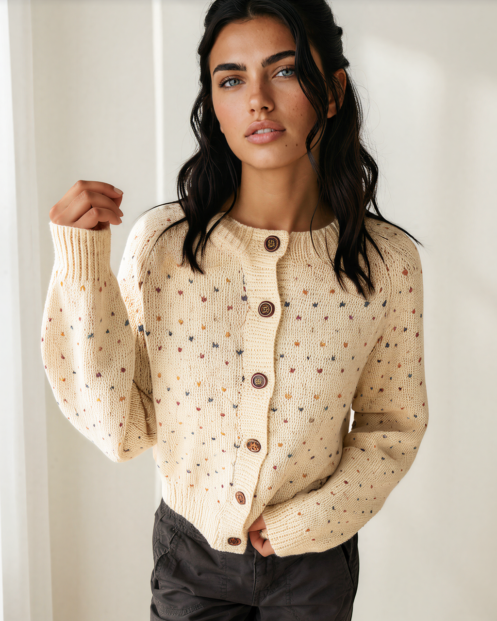 Cream speckled button-front knit cardigan with long sleeves