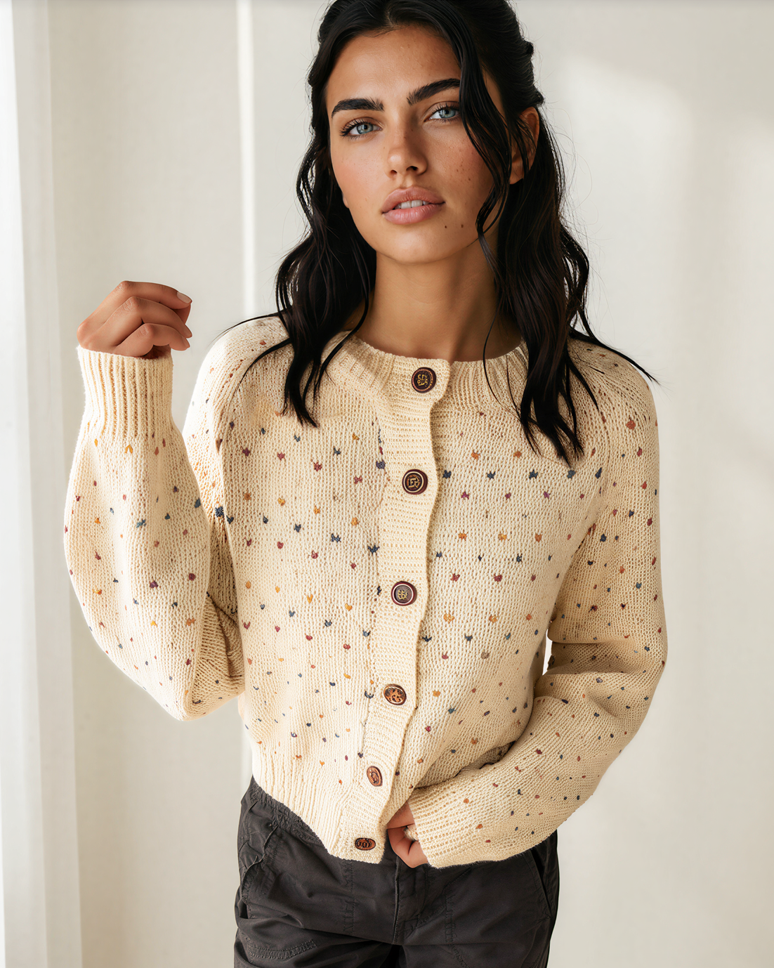 Cream speckled button-front knit cardigan with long sleeves