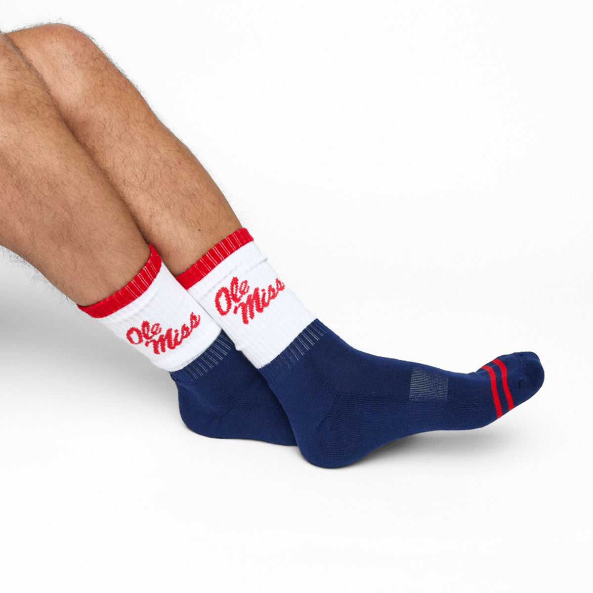 Navy and white crew socks with red stripes and Ole Miss script on the leg