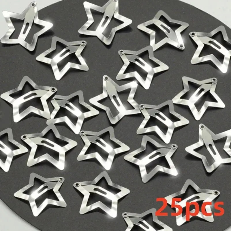 Silver star metal hair clips on a tray, shiny star-shaped barrettes with loops.
