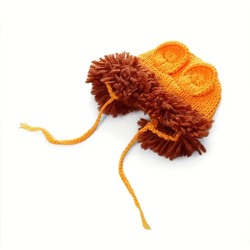 Knitted lion hat with ear shapes, brown furry trim and long yellow tie strings