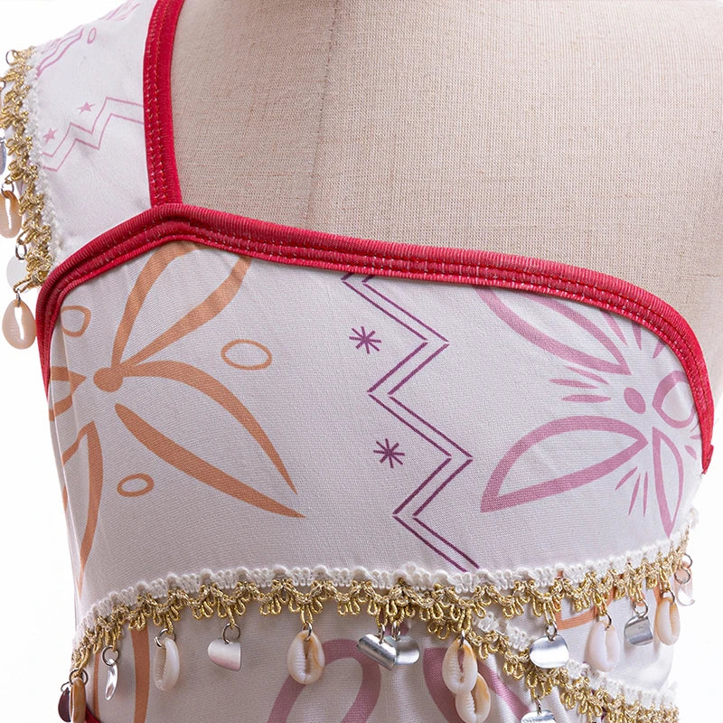Kids princess costume dress bodice close-up with white print, red piping, and gold fringe