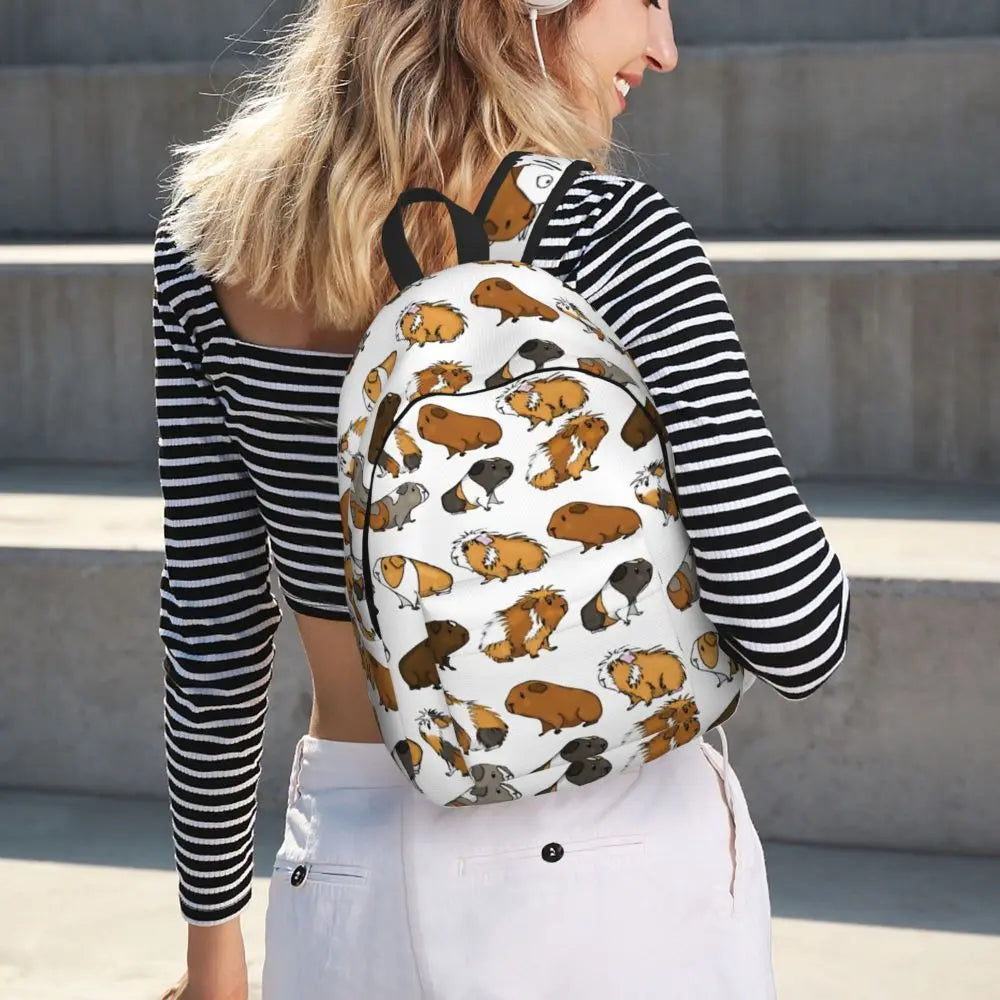 Guinea pig print backpack on person, white fabric with black straps and back view