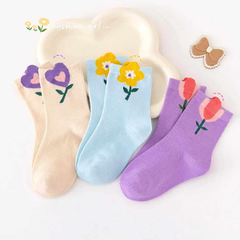 Five-pack girls crew socks in cream, light blue, purple, and pink with flower prints