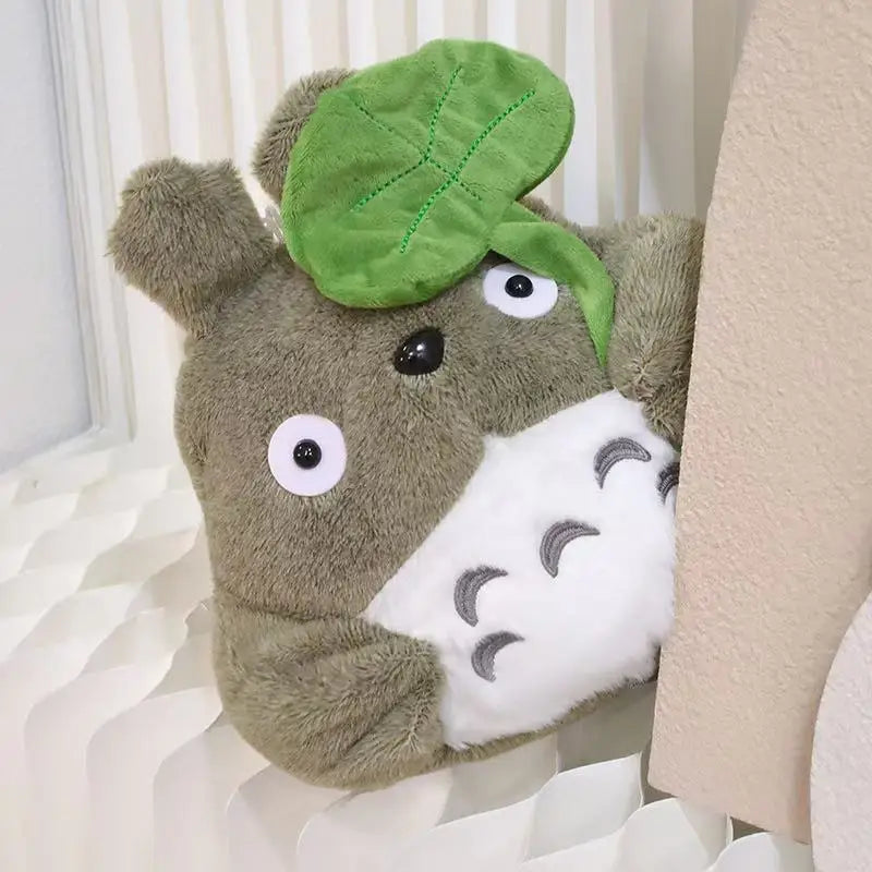 Cartoon forest creature plush pillow, brown teddy with green leaf cap and white cloud belly