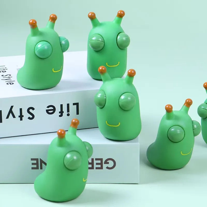 Green worm squeeze fidget toys with pop-out eyes in a group view
