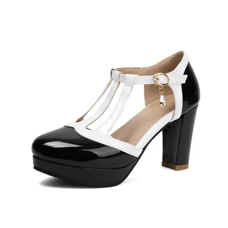 Women’s heeled T-strap pumps, white straps with black glossy patent toe and gold buckle charm