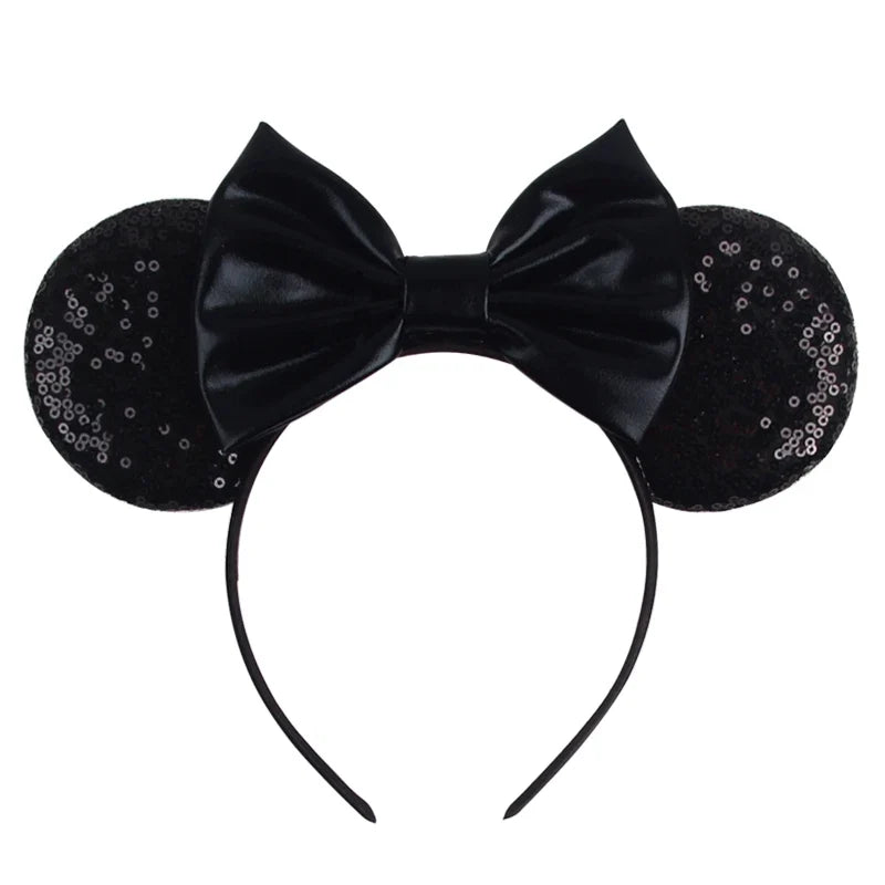 Black sequin Mickey-style ears headband with glossy black bow and curved band.