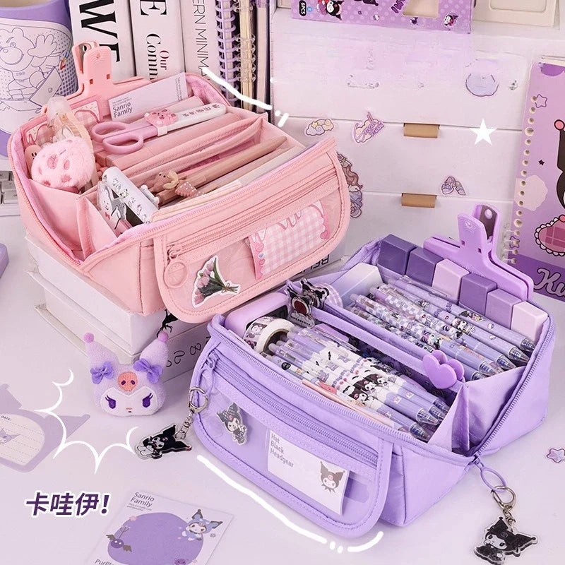 Pink and purple zip pencil cases side by side, both open with organizer pockets