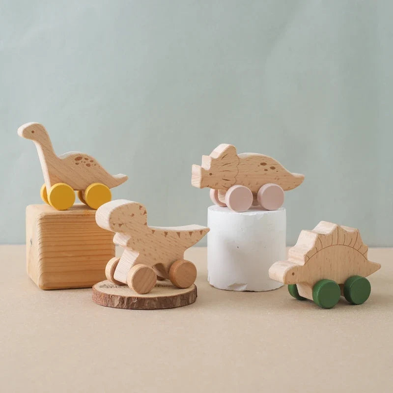 Wooden dinosaur teether car with pastel wheels and carved scales