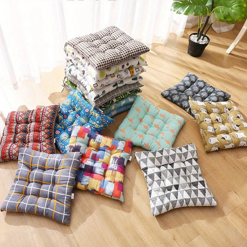 Stack of patterned square seat cushions in assorted colors and designs